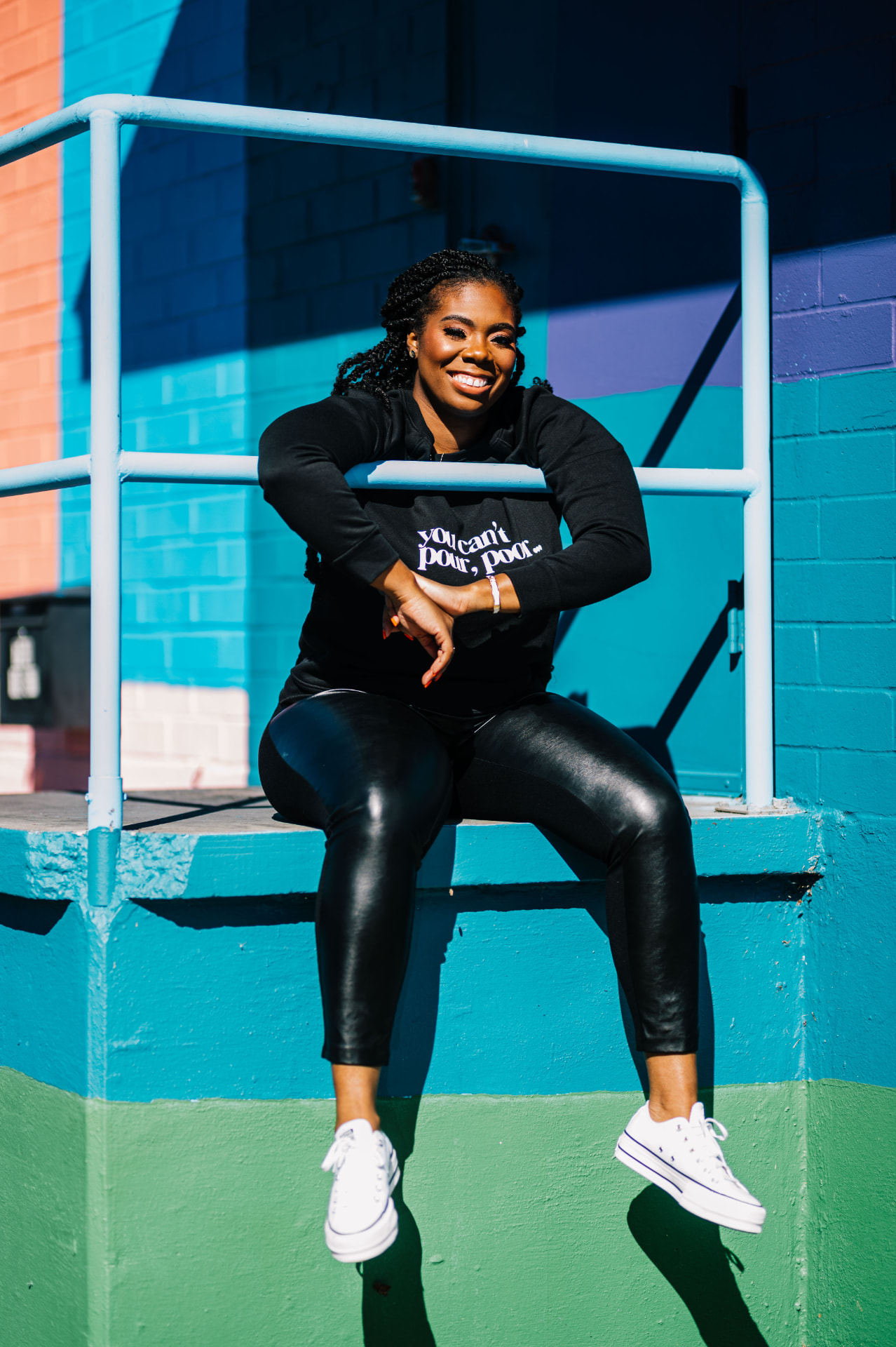 Geretta Patrice smiling against a colorful mural